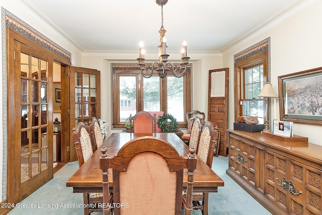 dining room featuring french doors, a chandelier, light carpet, and ornamental molding