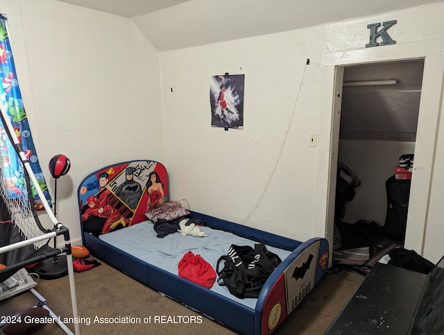 bedroom featuring a closet, carpet flooring, and lofted ceiling