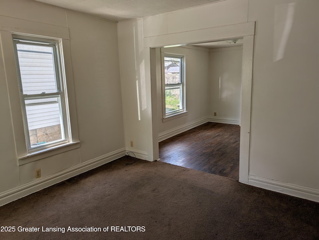 carpeted spare room with baseboards