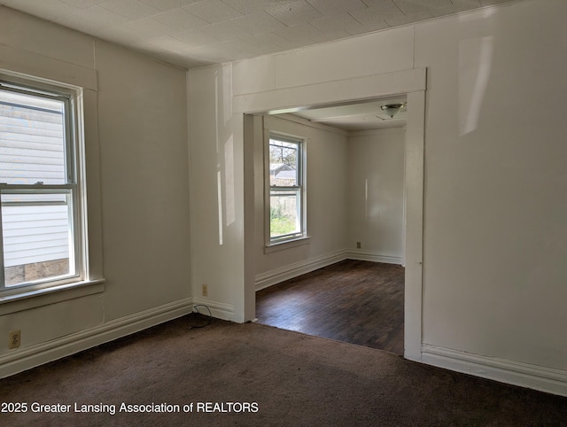 carpeted spare room with baseboards