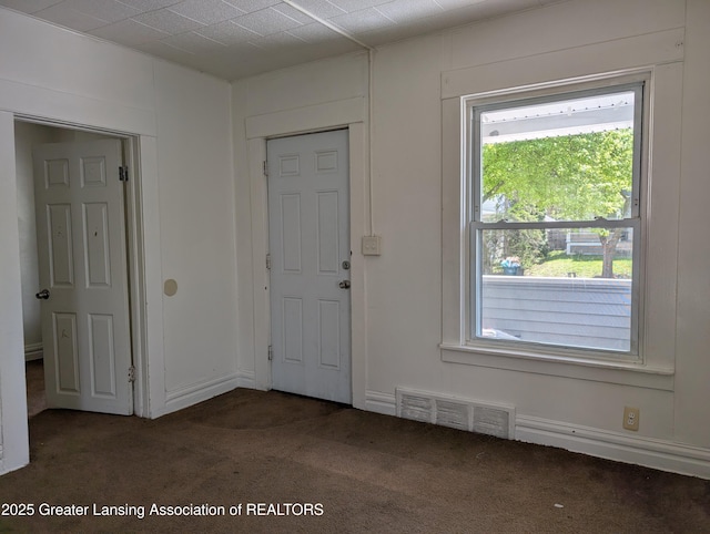 entryway with carpet flooring and visible vents