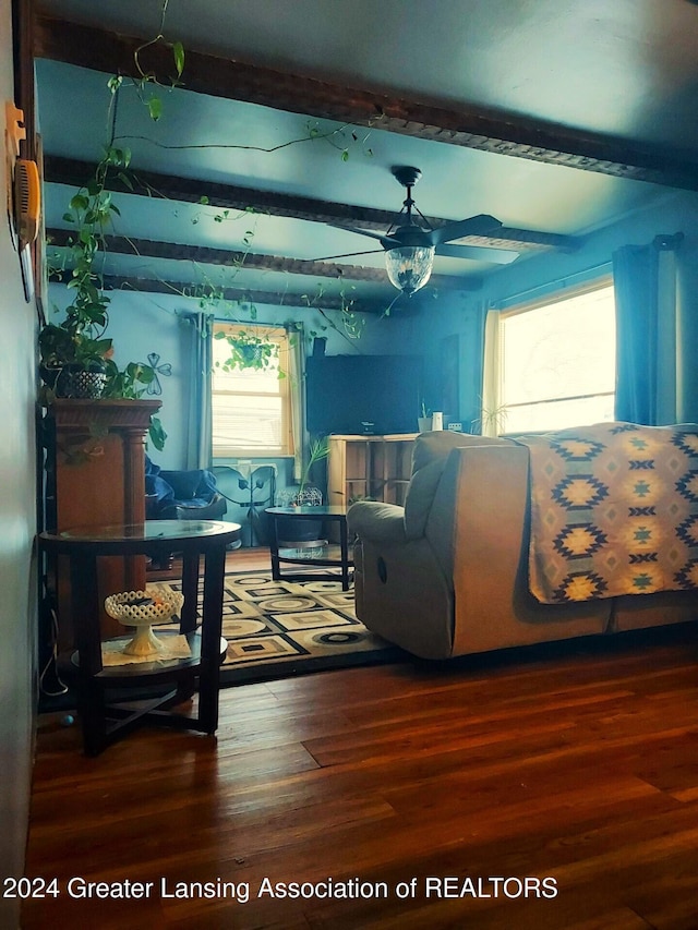 bedroom with hardwood / wood-style flooring and beamed ceiling