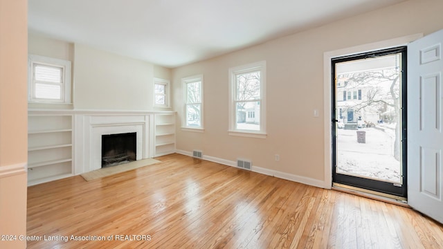 unfurnished living room with hardwood / wood-style floors