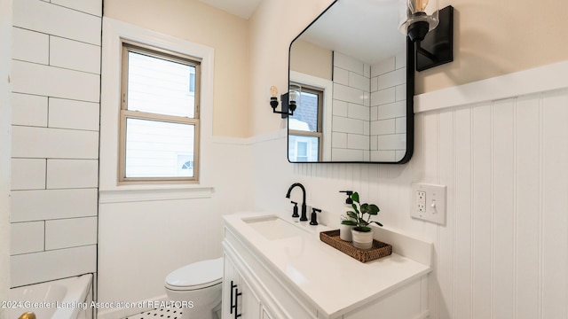 bathroom featuring toilet and vanity