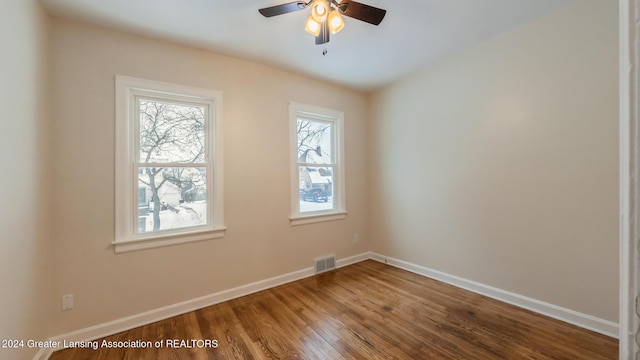 empty room with hardwood / wood-style flooring and ceiling fan