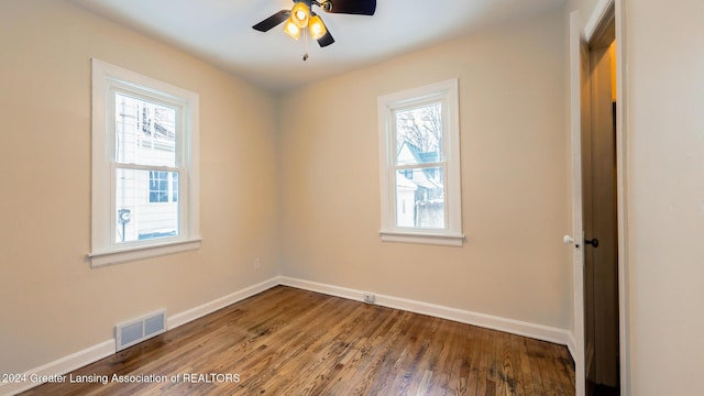 unfurnished room featuring ceiling fan, a wealth of natural light, and hardwood / wood-style flooring