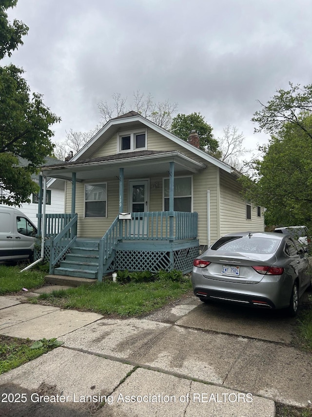 129 Clifford St, Lansing, MI 48912 - view of front of home with covered porch and a chimney