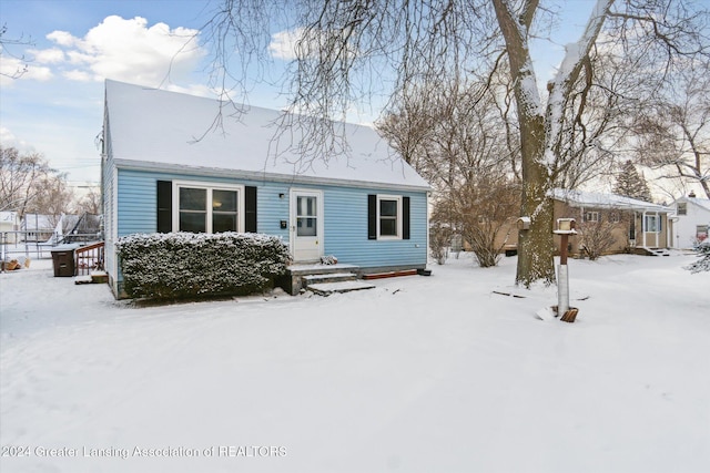 view of snow covered back of property