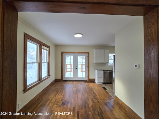 interior space featuring dark wood-type flooring, french doors, and plenty of natural light