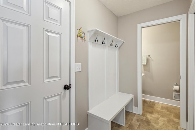 mudroom with a textured ceiling