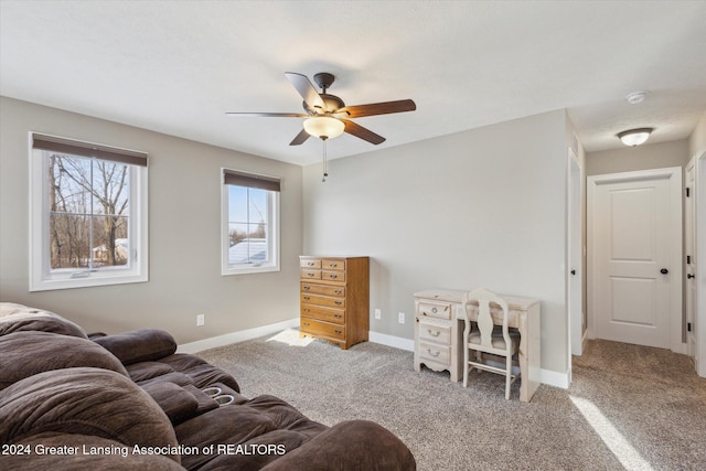 carpeted living room with ceiling fan