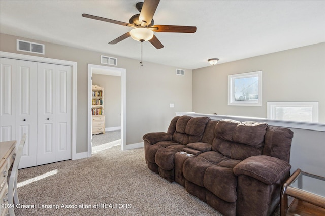 carpeted living room featuring ceiling fan