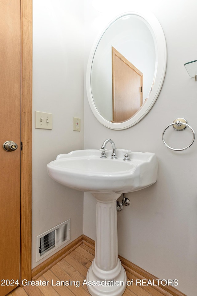 bathroom featuring hardwood / wood-style flooring and sink