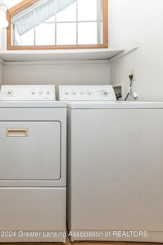 laundry area with separate washer and dryer and plenty of natural light