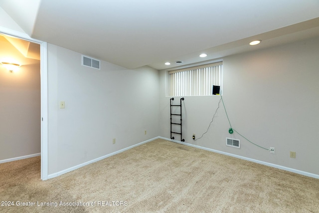 basement featuring light carpet