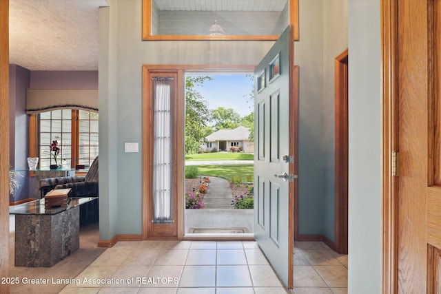 tiled foyer with a textured ceiling