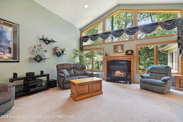 living room featuring a fireplace, high vaulted ceiling, and carpet