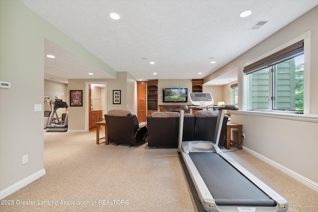 exercise room featuring a textured ceiling