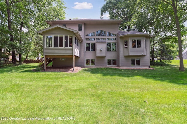 back of house with a yard and a sunroom