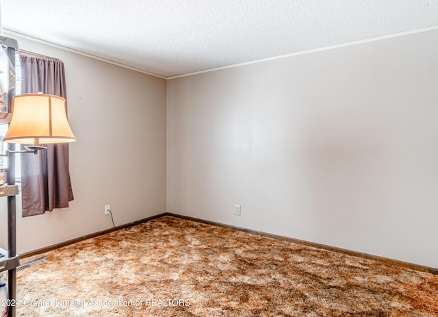 unfurnished room featuring carpet flooring and a textured ceiling