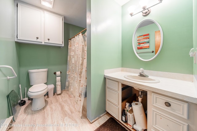 bathroom with vanity, toilet, and curtained shower