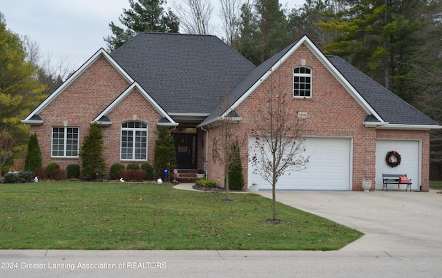 view of front of property with a garage and a front lawn