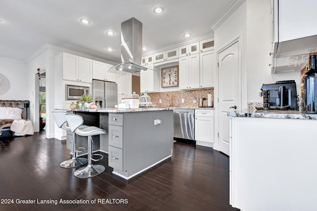 kitchen with white cabinets, stainless steel appliances, a kitchen island, and island range hood