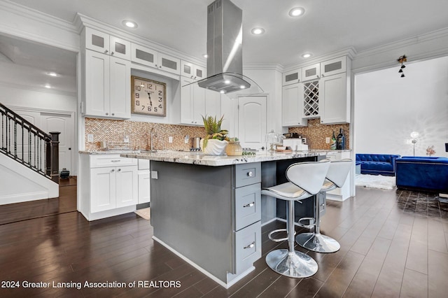 kitchen featuring island range hood, white cabinets, and a kitchen island