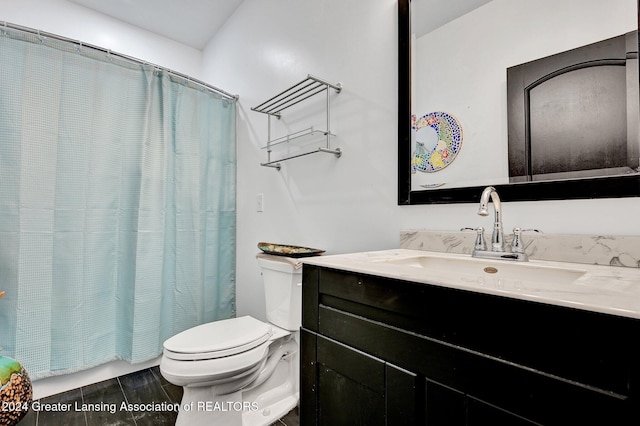 bathroom featuring vanity, curtained shower, and toilet