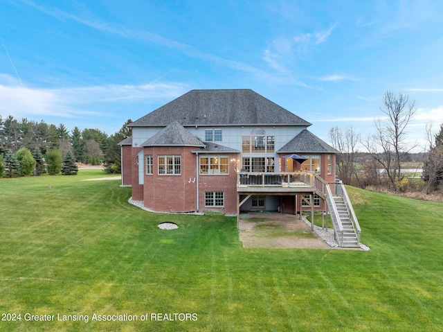 back of house with a patio, a balcony, a deck, and a lawn