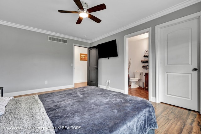 bedroom with connected bathroom, crown molding, dark wood-type flooring, and ceiling fan