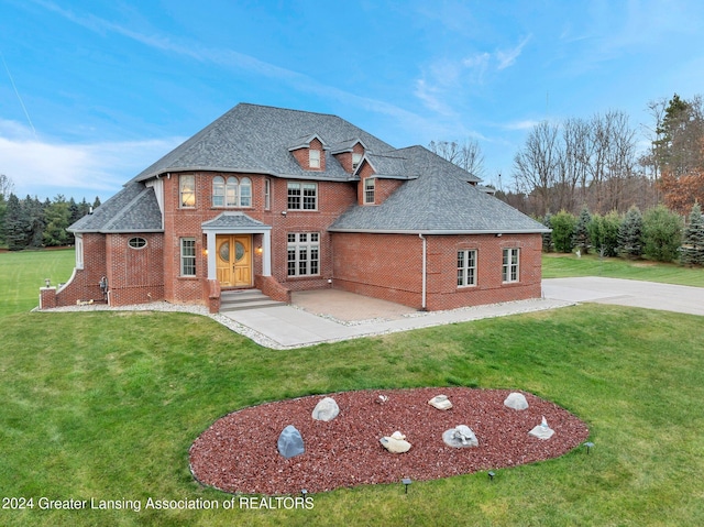 view of front of property with a patio and a front lawn