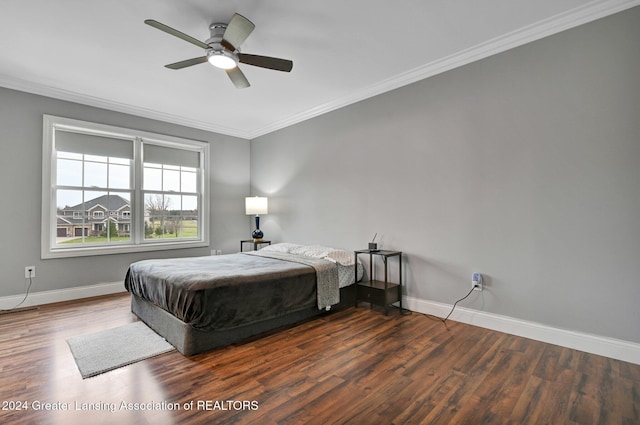 bedroom with crown molding, dark wood-type flooring, and ceiling fan