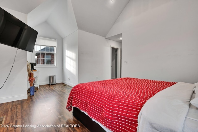 bedroom with wood-type flooring and lofted ceiling