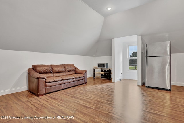 living room with lofted ceiling and light wood-type flooring