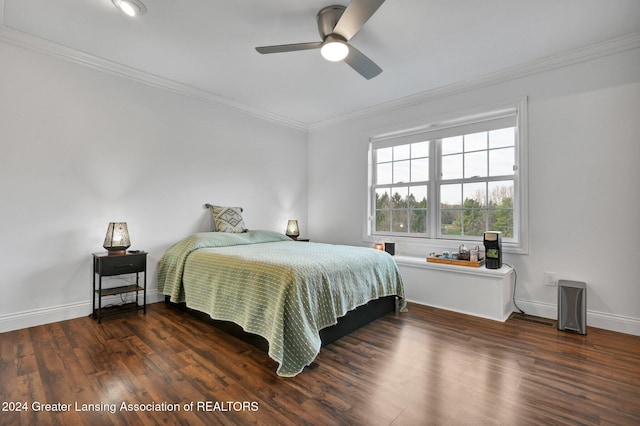 bedroom with ornamental molding, dark wood-type flooring, and ceiling fan