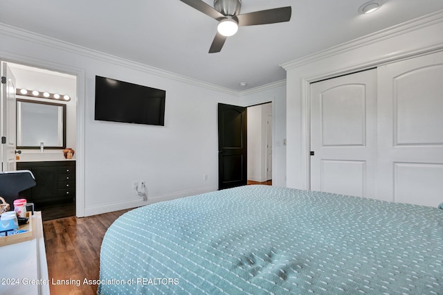 bedroom with ornamental molding, ceiling fan, dark wood-type flooring, ensuite bath, and a closet