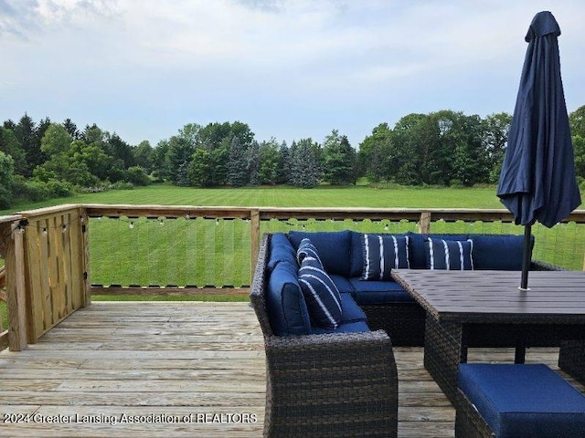 wooden deck featuring a lawn