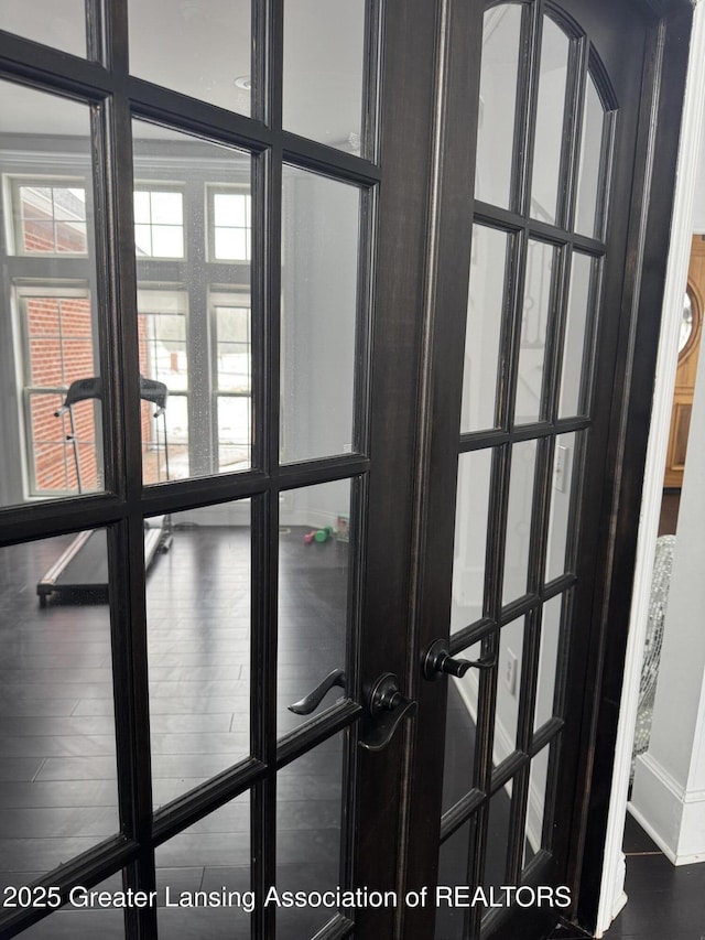 interior details featuring french doors and wood-type flooring