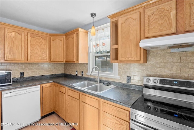 kitchen featuring pendant lighting, appliances with stainless steel finishes, tasteful backsplash, light brown cabinetry, and sink