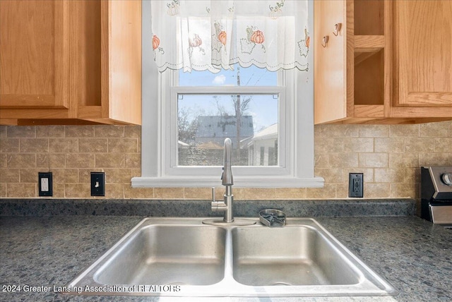 interior details featuring sink and tasteful backsplash