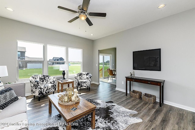 living room with ceiling fan, plenty of natural light, and dark hardwood / wood-style flooring