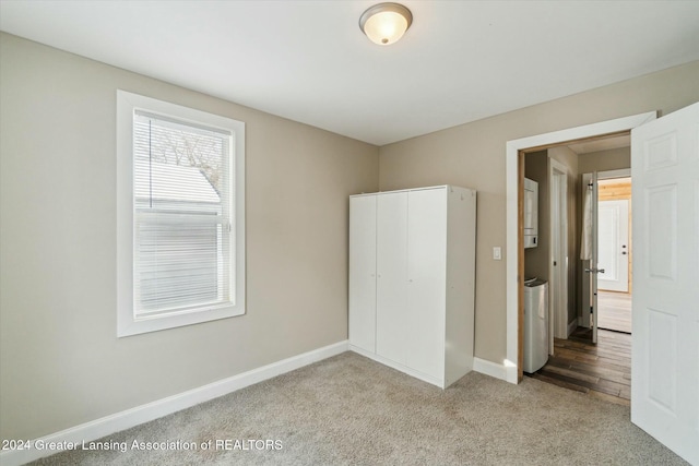 unfurnished bedroom featuring light carpet