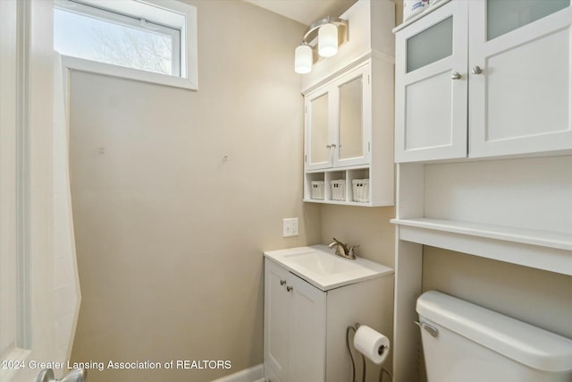 bathroom featuring toilet and vanity