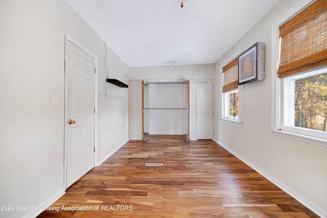 corridor featuring hardwood / wood-style floors