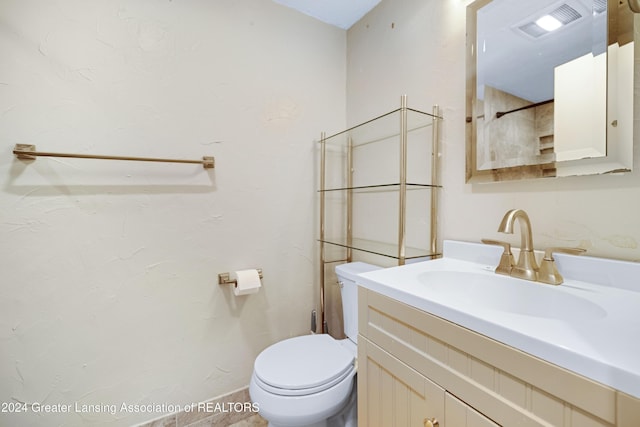 bathroom with toilet and vanity