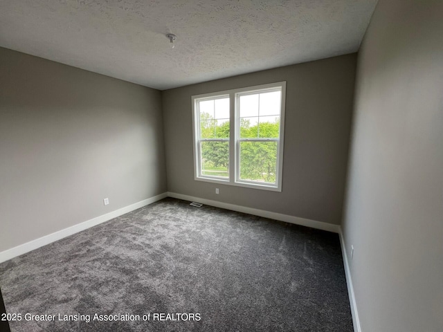 6097 Southridge Rd, East Lansing, MI 48823 - unfurnished room with a textured ceiling, carpet, baseboards, and a pendent fire sprinkler