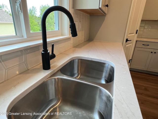 6097 Southridge Rd, East Lansing, MI 48823 - kitchen view of a sink, decorative backsplash, and dark wood finished floors
