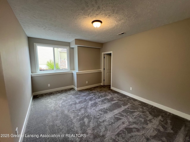 6097 Southridge Rd, East Lansing, MI 48823 - unfurnished bedroom with carpet, a textured ceiling, and baseboards