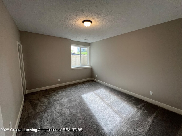 6097 Southridge Rd, East Lansing, MI 48823 - unfurnished room with a textured ceiling, carpet flooring, and baseboards